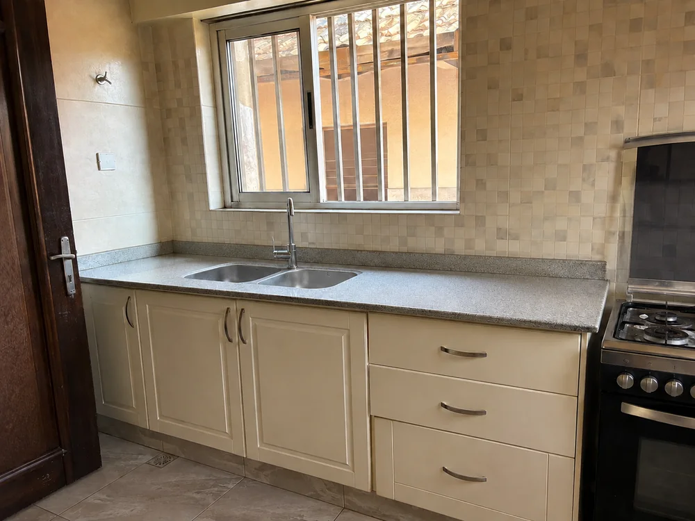 The same kitchen with clean counters and dishes put away